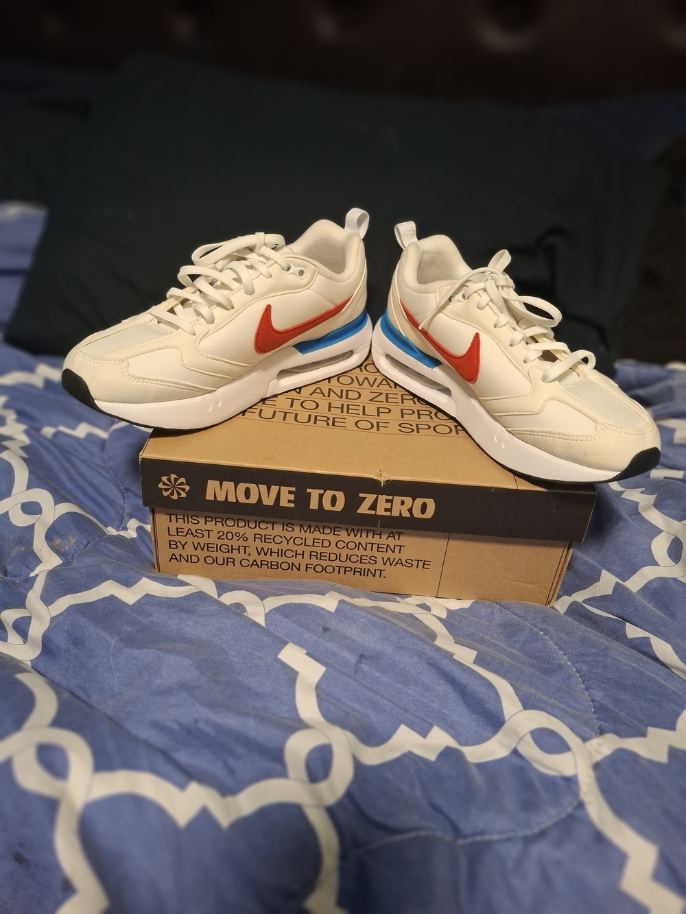 Nike Kids Cream Sneakers with Red Swoosh and Blue Heel Accent